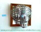 3 demensionial mask made from tin on display at Penn State Altoona Art Festival