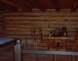 photo of the inside of a fort cabin and table and chairs at Central Pennsylvana historic landmark Fort Roberdeau