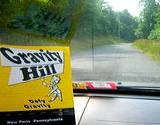 A brochure on the dashboad of car of Gravity Hill