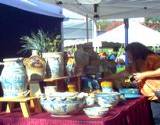 photo of a booth at the hartzlog festival displaying pottery