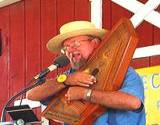 a man in a straw hat playing folk music on a autoharp at the Kutztown Festival