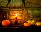 photo of a lit candle with pumpkin and gourds to decorate Old Bedford Village Colonial Christmas event