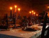 photo of a dinner table sat with lit candles at Old Bedford Village Colonial Christmas event