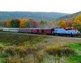 image of train travelling along mountain traintracks