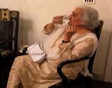 Elderly woman drinking a glass of water