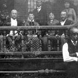 PA Heritage Discovery Center picture of people sitting on porch before the great Johnstown Flood African American standing in front of porch