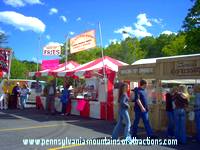 food booth vendors serving ethnic foods at the Blair County PA Arts Festival