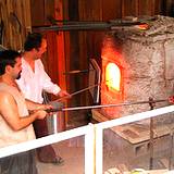 A photo of a man heating glass in furnace at Clearfield County Fair