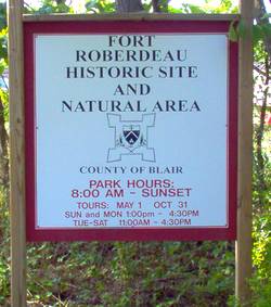 photo of a sign at Central Pennsylvania historic landmark Fort Roberdeau telling the times and opening and closing dates