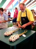 photo of a man demonstrating garlic braiding at the Pocono Garlic Festival