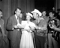 Photo of James Stewart singing with Roy Rodgers and Dale Evens