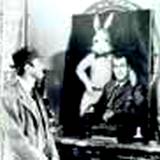 A photo of a man looking at a portrait of Jimmy Stewart and his pooka, Harvey