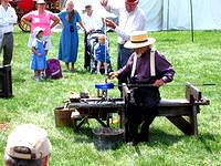 A glass blower creating a piece of art at the Kutztown Fair