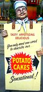 photo of a man wearing a sign advertising potato cakes at Mountain Days celebration