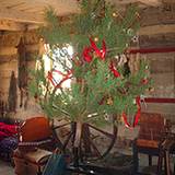 photo of an old fashioned Christmas tree on a spinning wheel at Old Bedford Village Colonial Christmas event