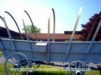 An old covered wagon, without the cover, standing as Pennsylvania history at Old Bedford Village