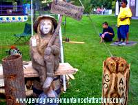 Chainsaw carving saying Sweet Cider 1 cent, Hard Cider 5 cents