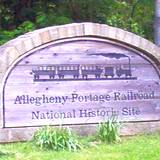 photo of a large rock with Allegheny Portage Railroad Museum logo printed on it