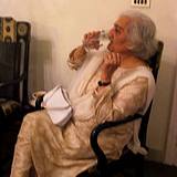 Elderly woman drinking a glass of water