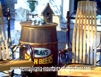 photo of two handmade rockers sit on the porch of the Artison Trail gift shop in front of the Jean Bonnet Tavern