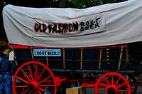 A covered wagon with big red wheels selling root beer at the Kutztown Fair
