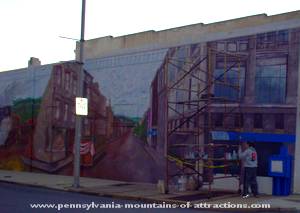 mural artist Pam Snyder working on her mural