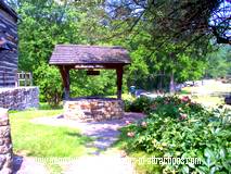 photo of an old well located next to a beautiful old church at Old Bedford Village