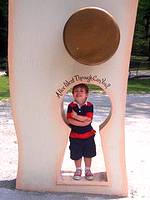 small boy standing in a keyhole at Storybook Forest